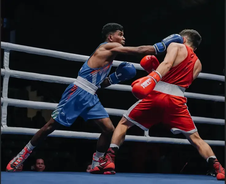 India's Vishvanath Suresh celebrates after winning his opening bout at the U-23 Asian Boxing Championships in Jakarta.