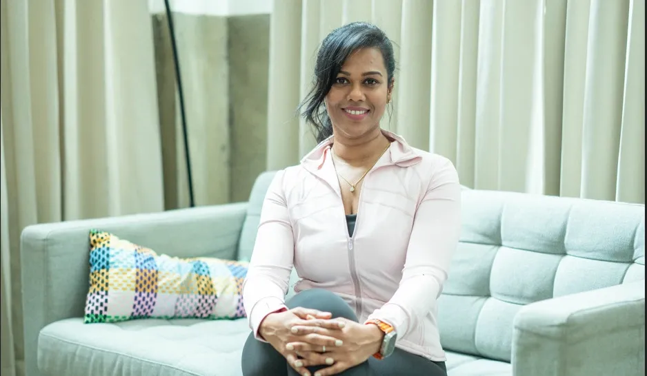 Woman wearing versatile activewear transitioning from workout to everyday activities in an urban setting